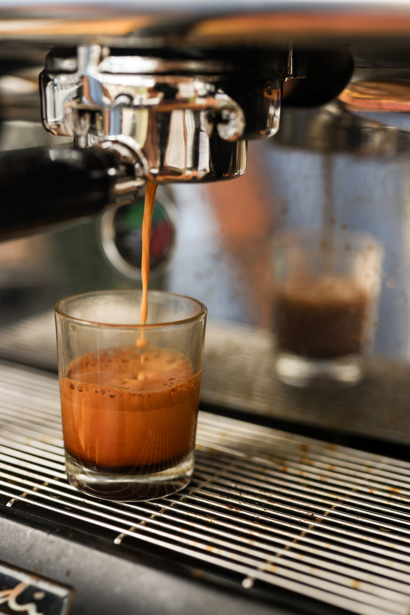 Barista tamping espresso at the Slow Down Coffee cart